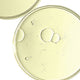 Close-up of a clear plastic lid with bubbles on a white background.