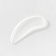 White cream smear on a light gray background.